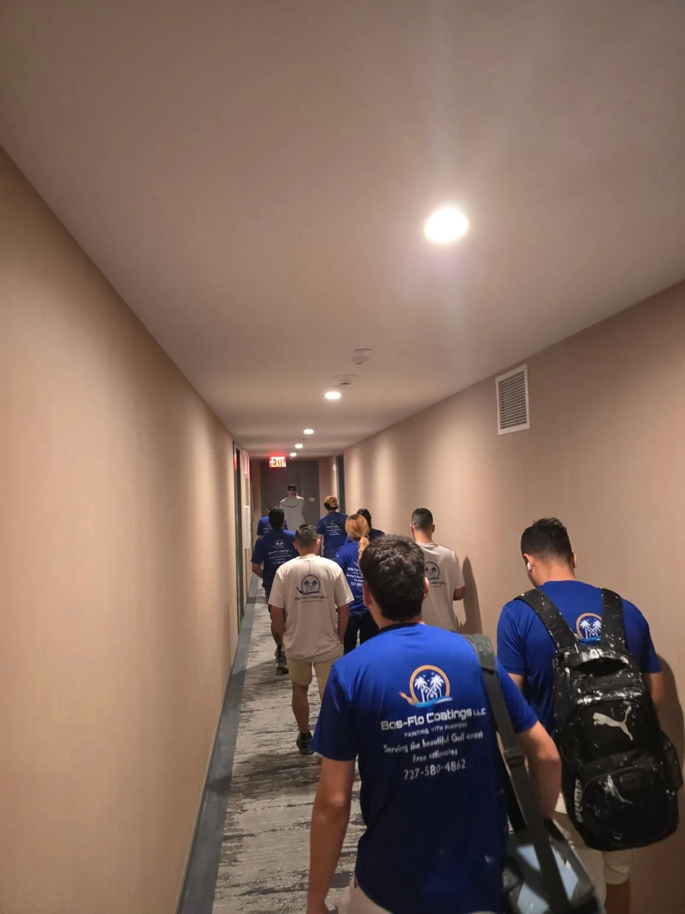 Bos-Flo Coatings crew walking through a commercial hallway in matching company shirts